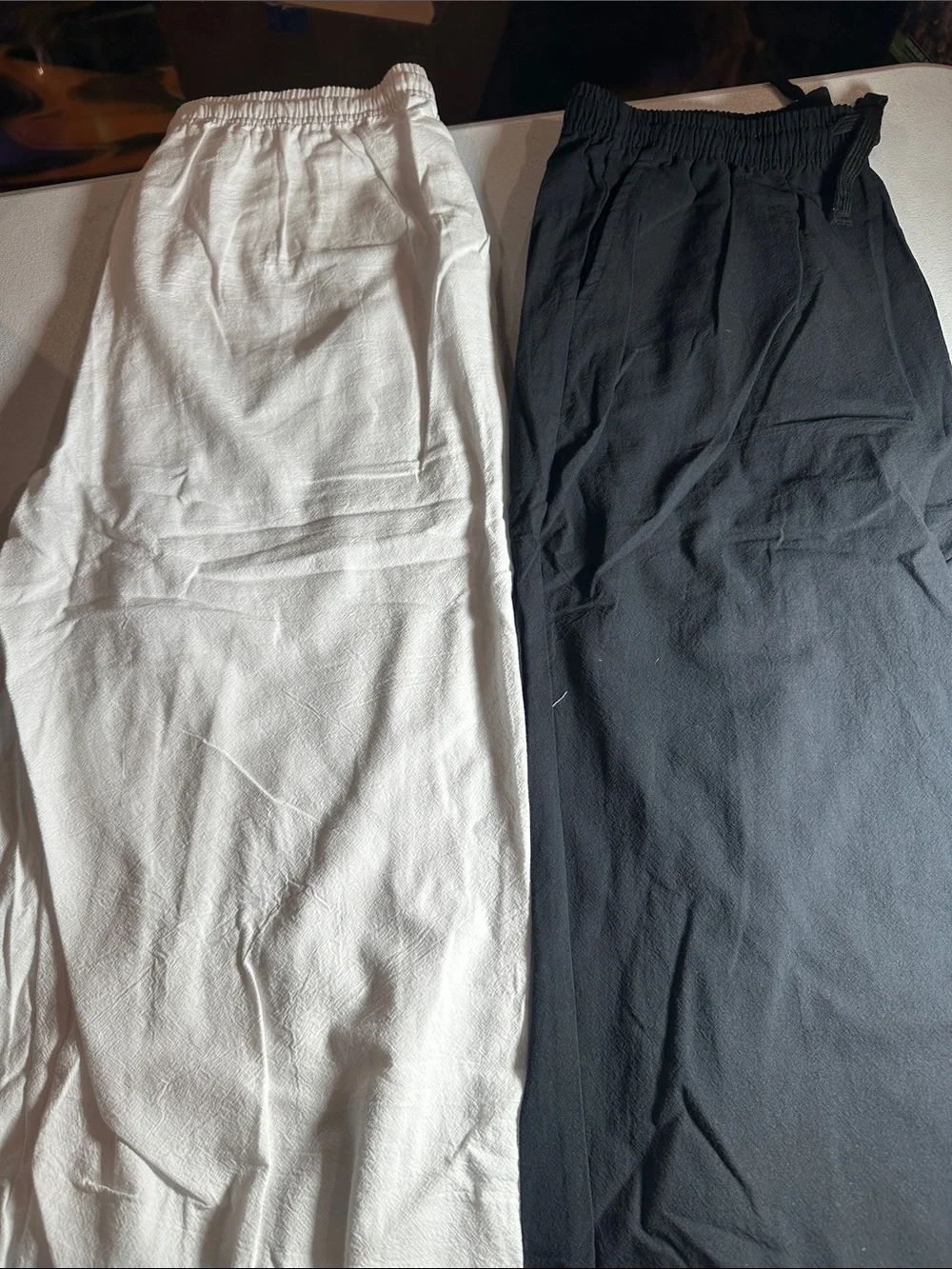 2 pack of Women's lightweight pants. One white and one black pair of medium pant